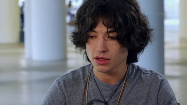 Ezra Miller as an intern in a T-shirt