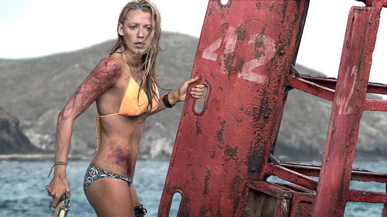 A surfer stranded on a buoy 