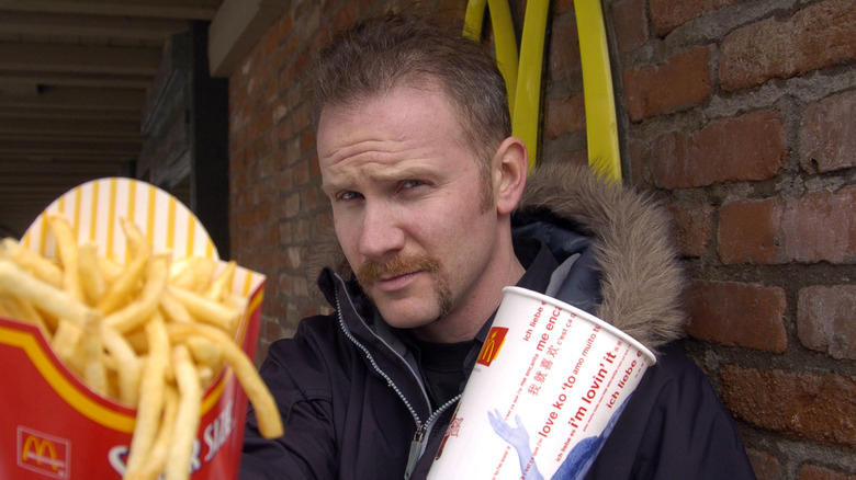 Morgan Spurlock holding McDonald's fries and cup