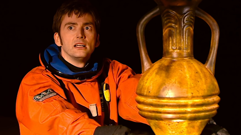 Tenth Doctor holding ancient urn