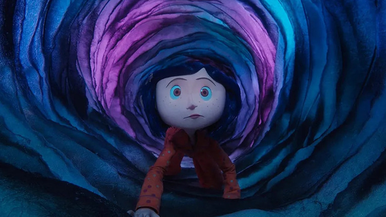 Coraline crawls through swirls of blue and purple