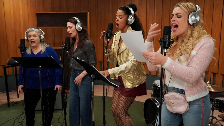 4 women singing in recording studio