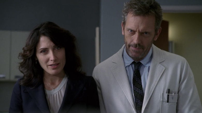 House and his partner look on