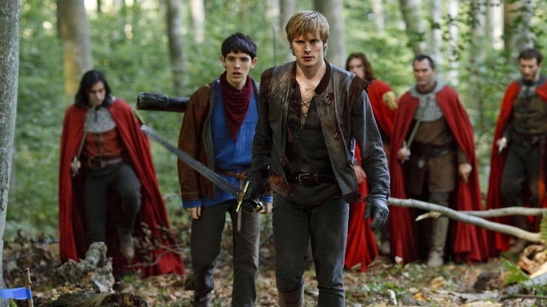 Arthur, Merlin, and knights in the forest