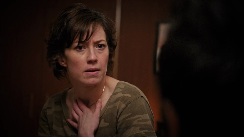 Nora Durst furrowing her brows and pressing her hand against her chest