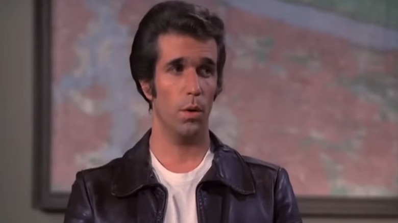 Arthur "Fonzie" Fonzarelli standing in front of a map