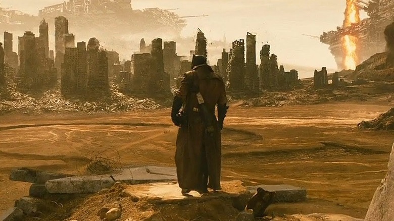 Batman overlooks a destroyed city