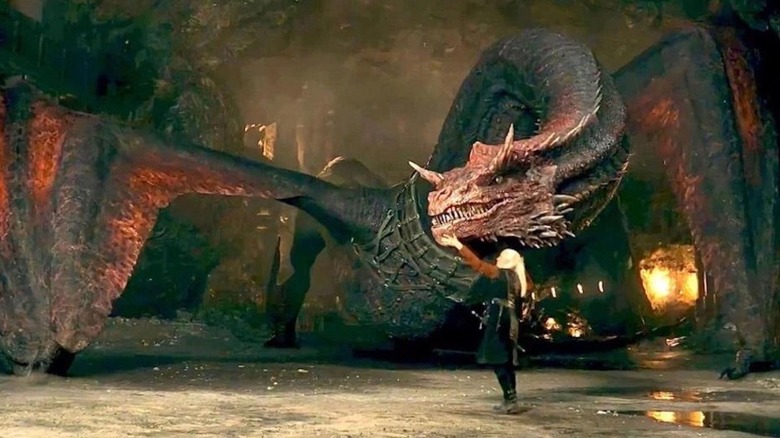 Daemon Targaryen pets his dragon Caraxes.