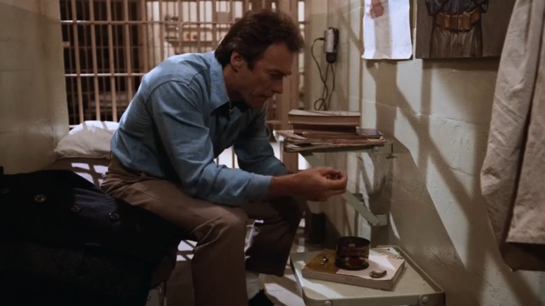 Frank Morris fashioning a tool on his cot in his cell in Escape From Alcatraz