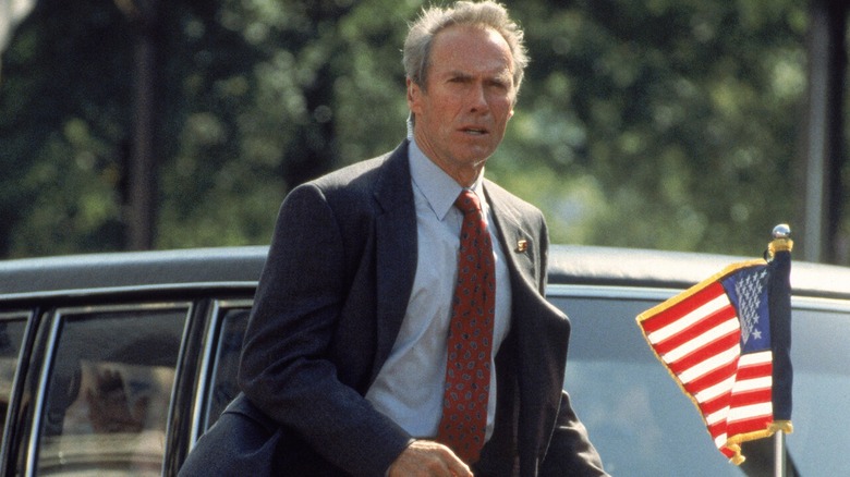 Secret Service Agent Frank Horrigan standing beside the presidential limo in In the Line of Fire