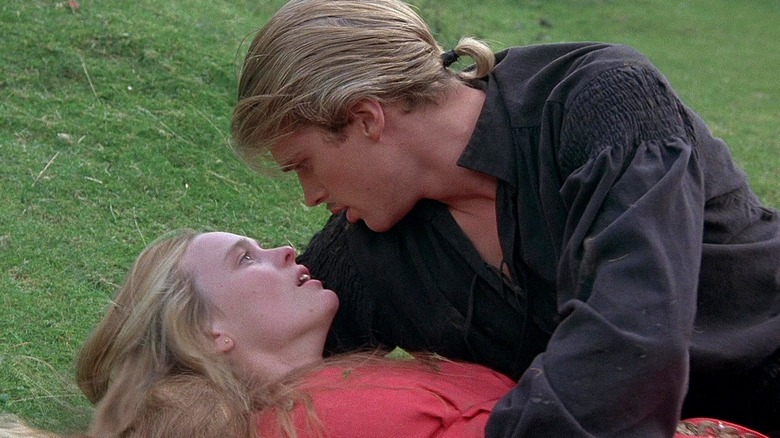 Westley looks into Buttercup's eyes as she lies in the grass in 