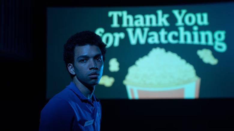 Owen stands in a movie theater in "I Saw the TV Glow" (2025)