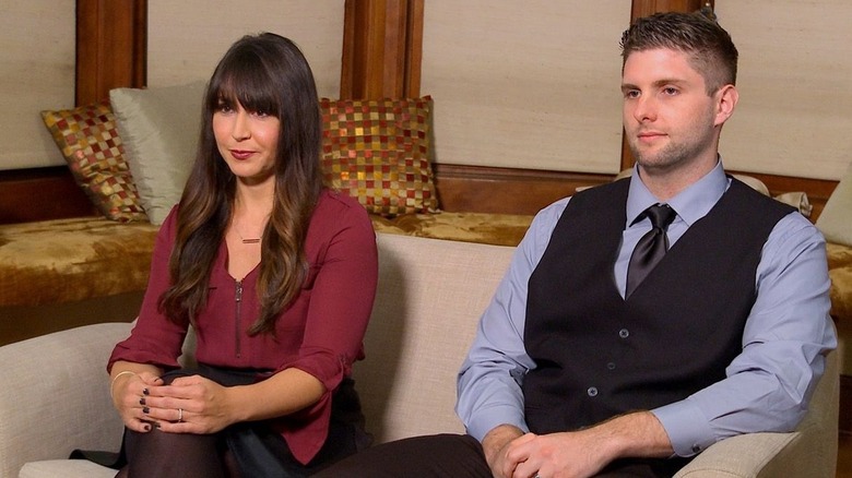 "Married at First Sight" Season 5 couple Danielle and Cody sitting apart on a love seat