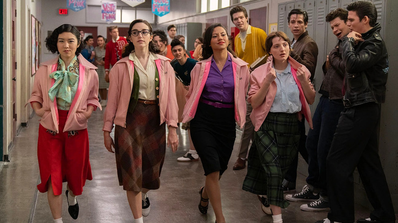 Pink Ladies walking down hallway