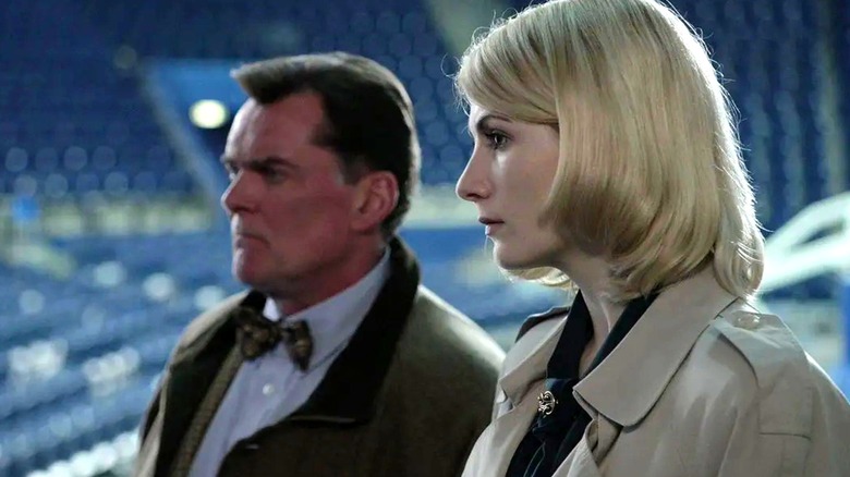 Grimes and O'Neill stand in a stadium.