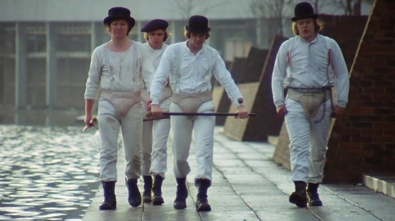 Droogs walking by river