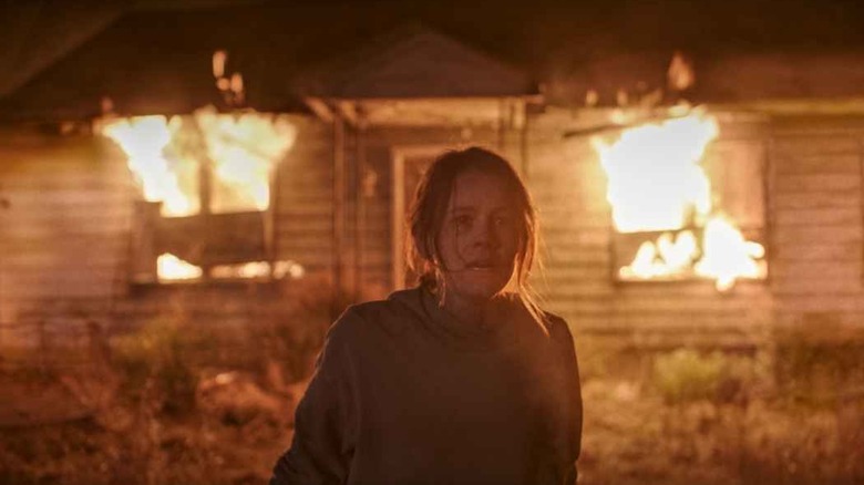 Rose walking away from a burning house