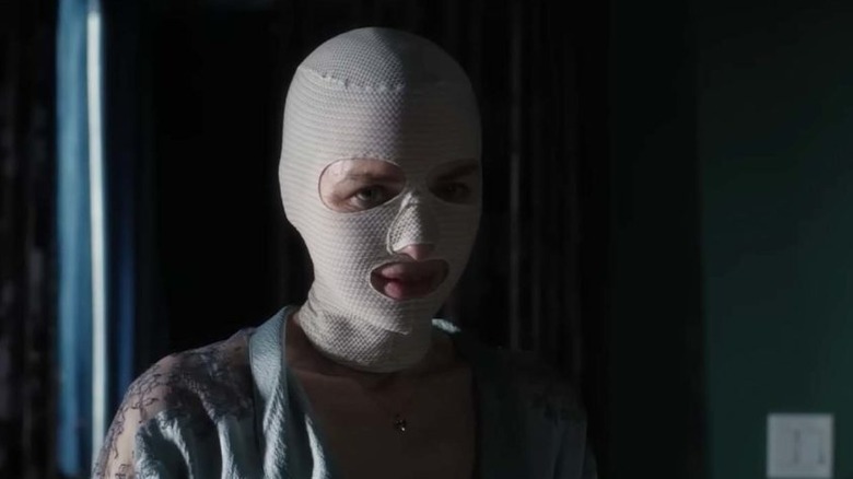 Naomi Watts, her face wrapped in a bandage