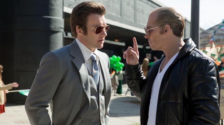 Whitey Bulger wags his finger in John's face in "Black Mass (2015)