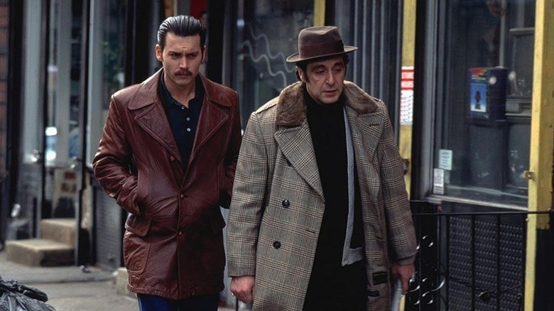 Donnie Brasco walks with Lefty down a busy street (1997)