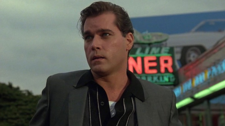 Henry Hill stands in front of a diner.