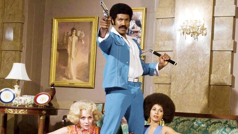 Michael Jai White with two women and a gun