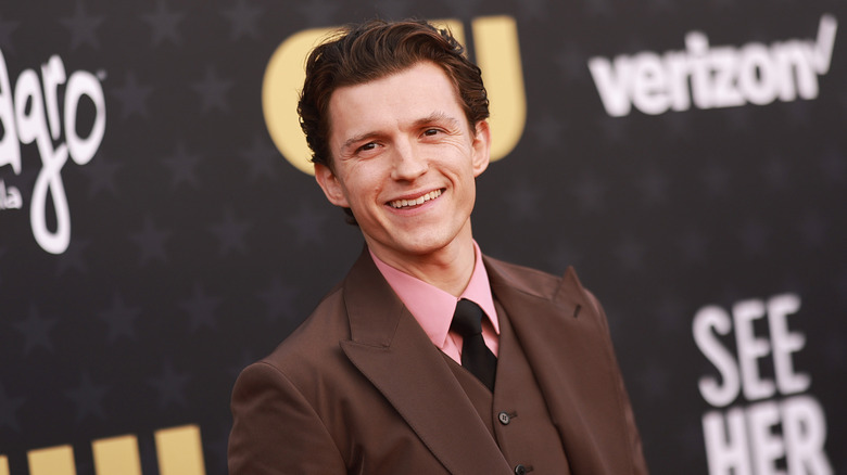 Tom Holland smiling at CW event