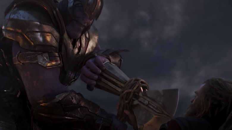 Thanos pins Thor to the ground