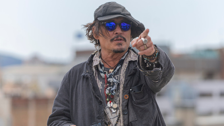 Johnny Depp points dressed eccentrically