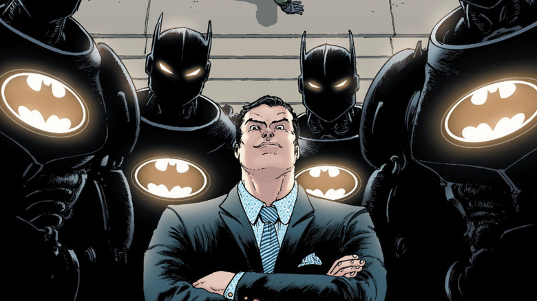 Bruce Wayne stands with his Ro-Bats