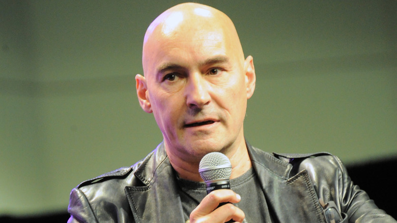 Grant Morrison holding a microphone