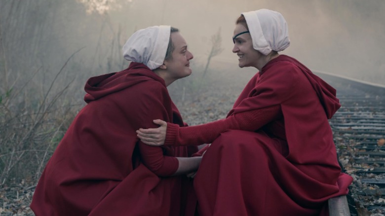 June and Janine embrace on a train track in "The Handmaid's Tale" (2016)