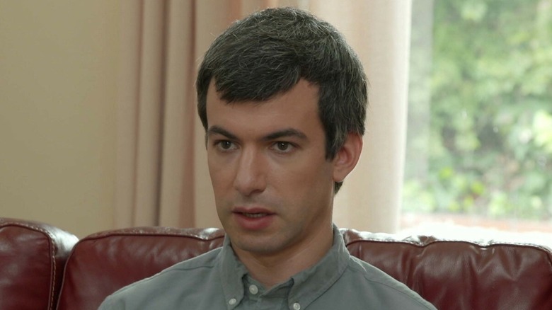 Nathan Fielder sitting on a couch