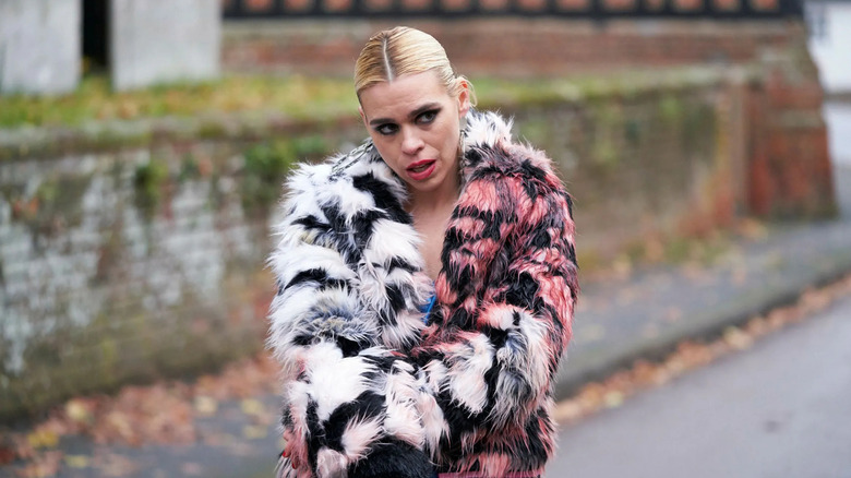 Suzie in a fur coat covered in blood on one side in I Hate Suzie