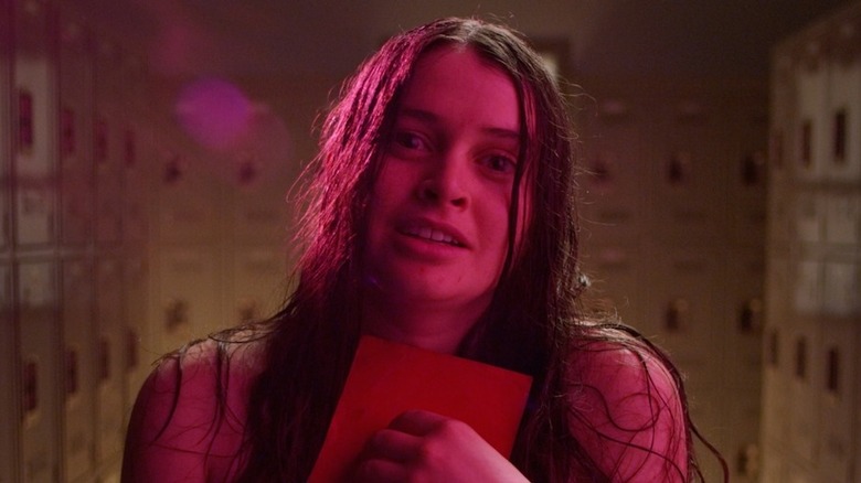 Woman in locker room clutching letter