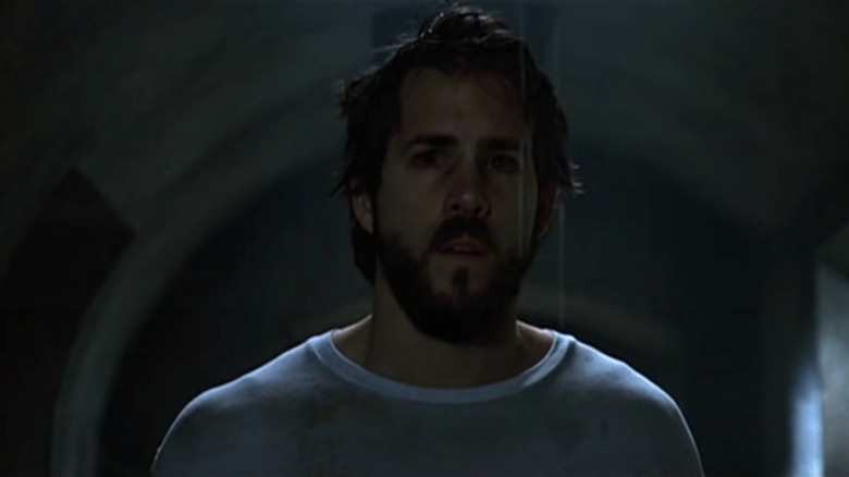 Ryan Reynolds staring at something in The Amityville Horror