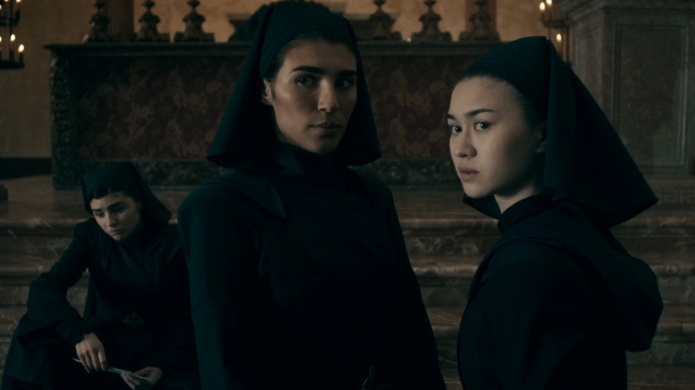 Three nuns look on with suspicion