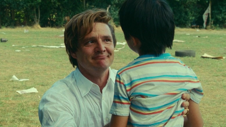 Maxwell Lord holds his son