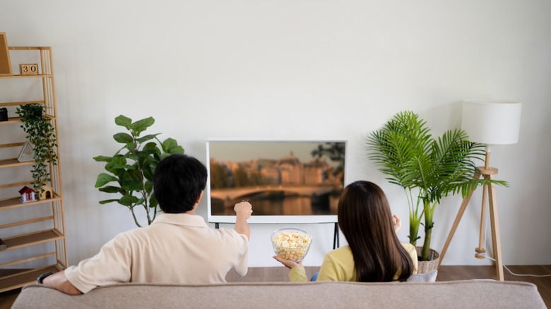 two people watching TV