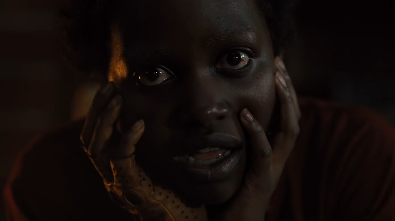 Us' Lupita Nyong'o holding her face