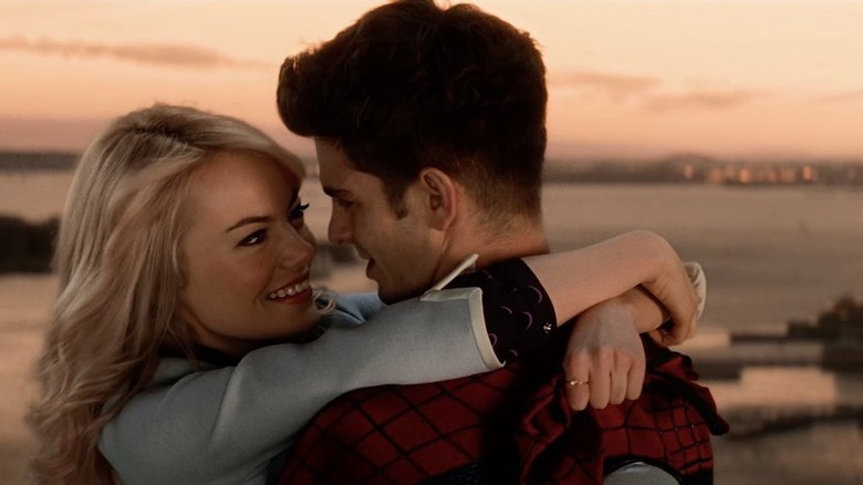 Gwen embracing Peter on a bridge