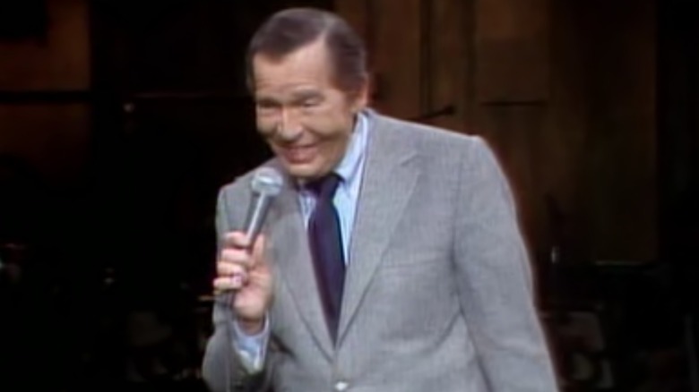 Milton Berle smiling into microphone