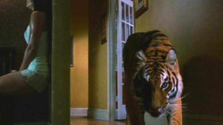 Briana Evigan hides from a tiger