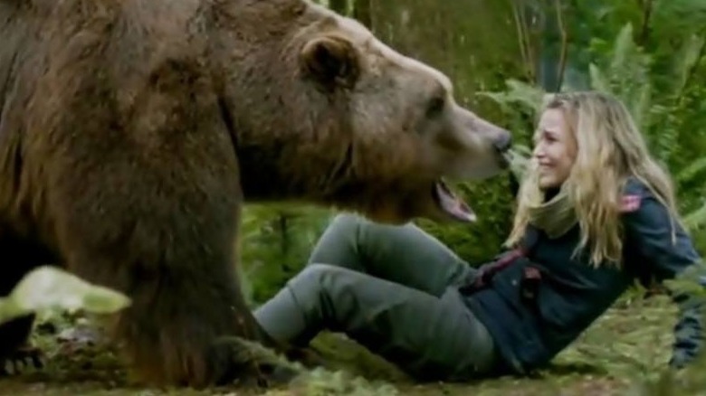 A bear stands over Piper Perabo