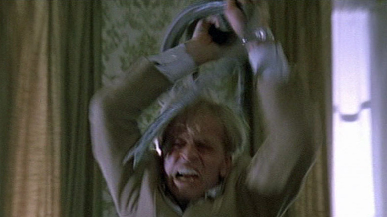 Klaus Kinski holds a snake