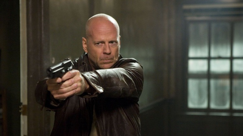 An armed John McClane proceeds down a hallway in "Live Free or Die Hard" (2007)