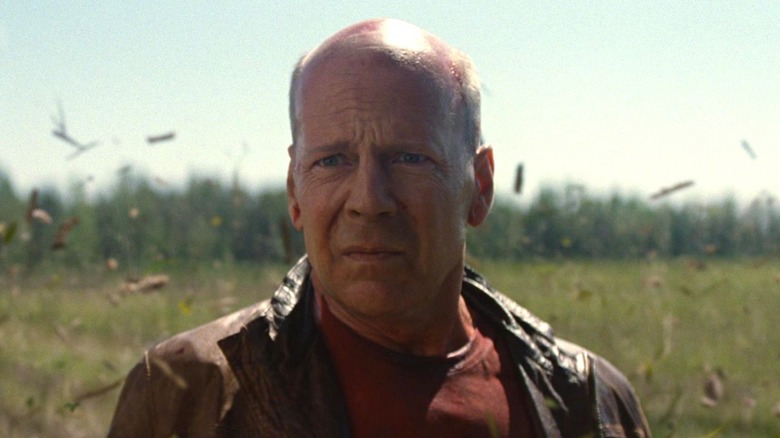 Old Joe standing in a field in "Looper" (2012)