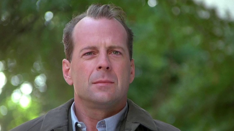 Malcolm Crowe stands beneath a tree in "The Sixth Sense" (1999)