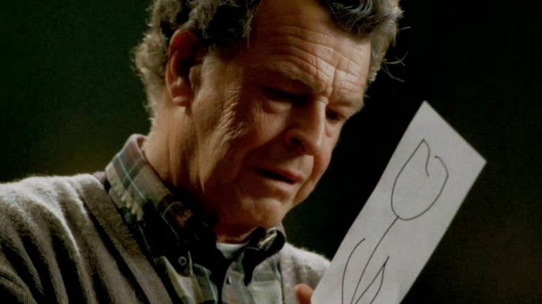 Walter holding drawing of white tulip 