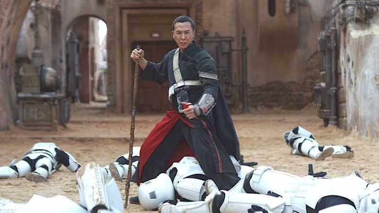 Chirrut Îmwe standing over the Stormtroopers he defeated